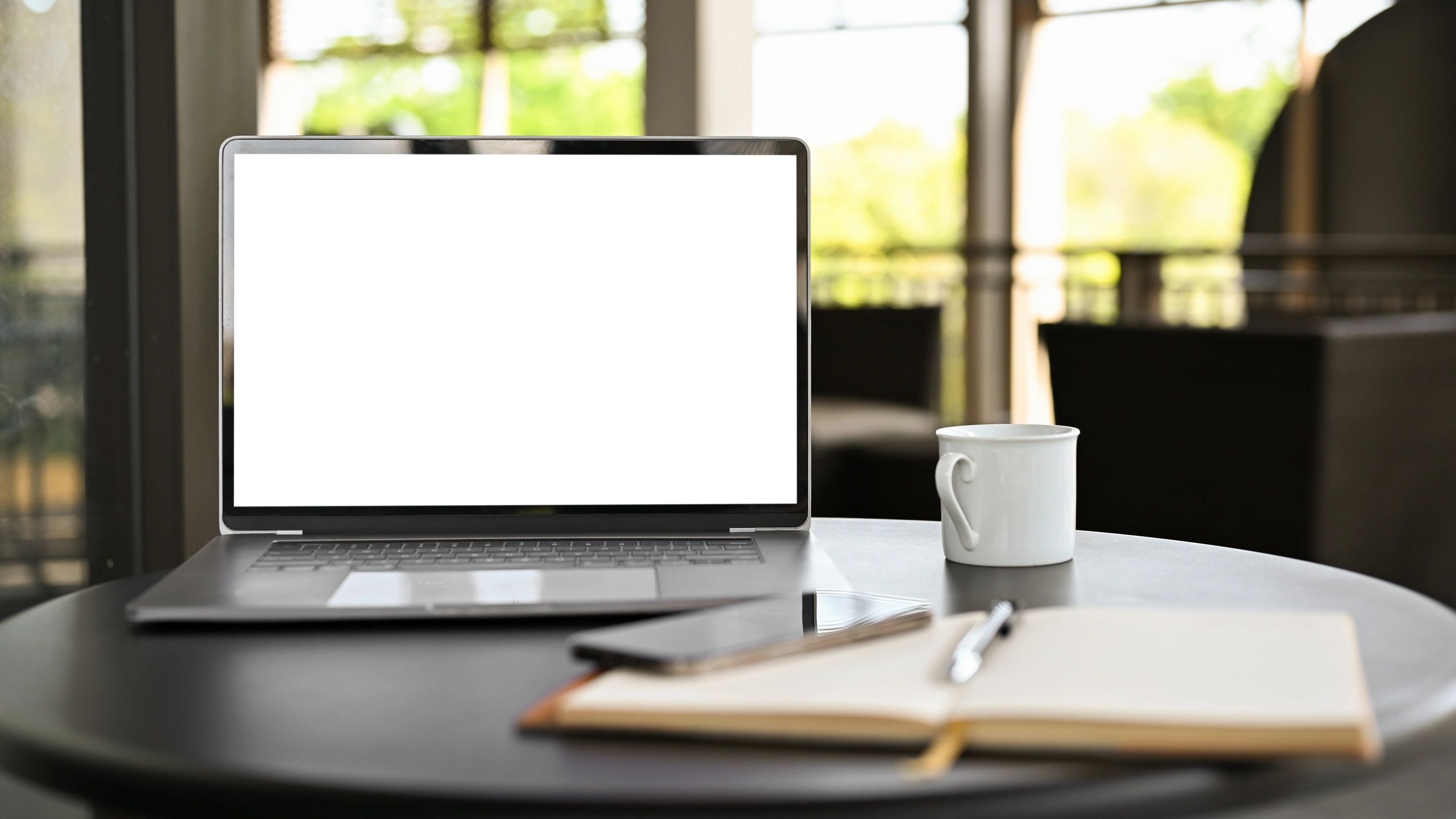 Laptop and notebook in a learning workspace
