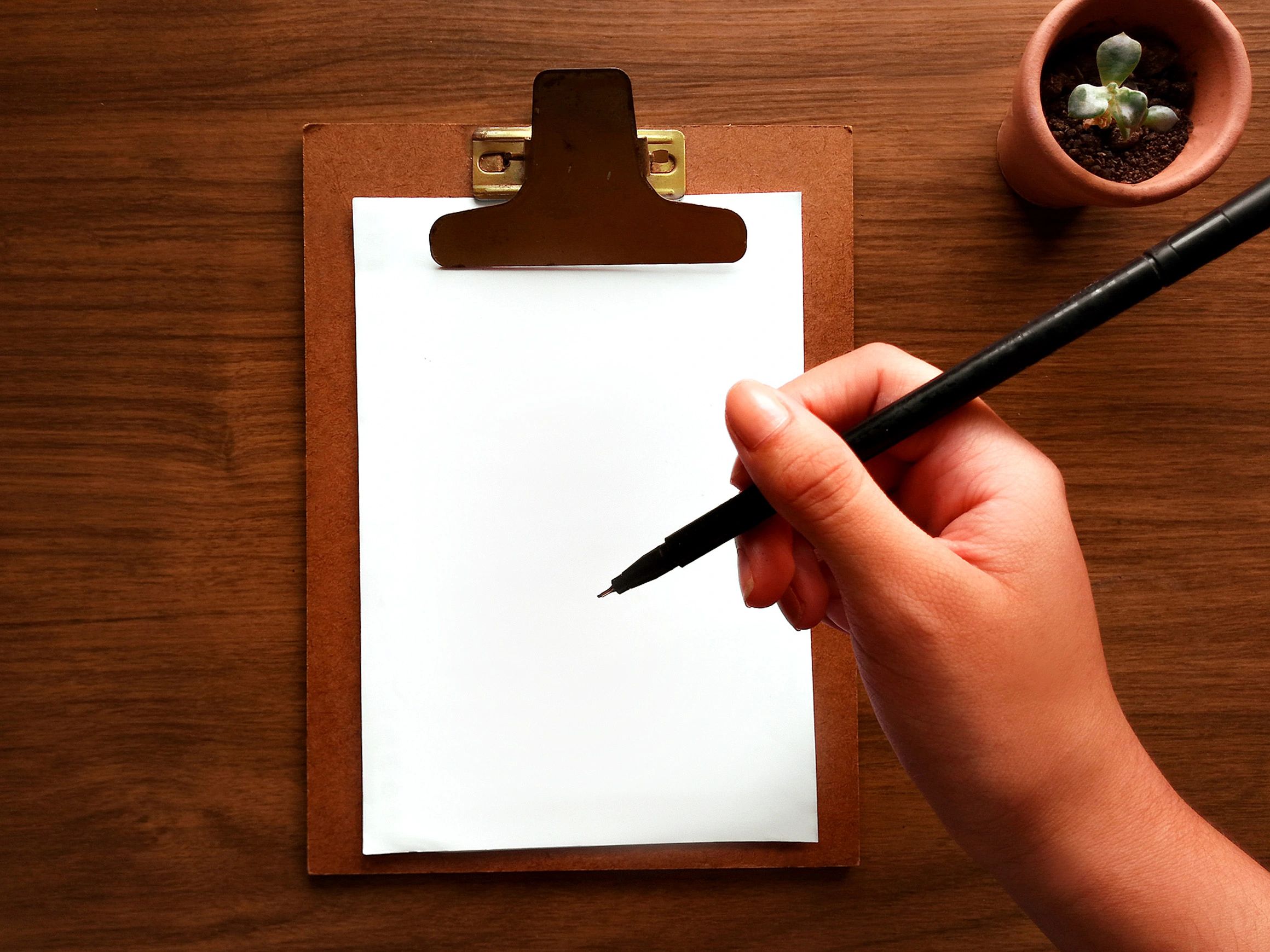 Clipboard and pen on a desk for planning certification goals