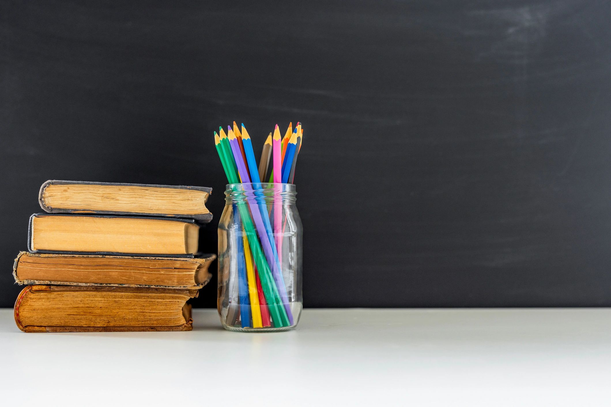 Books and colored pencils for exam preparation